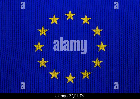 Bandiera dell'Unione europea sulla tessitura dei tessuti. Sfondo astratto per il design. Foto Stock