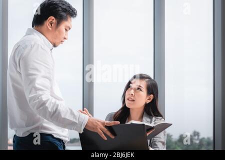 Il lavoro di squadra degli uomini d'affari è serio durante il Meeting Together, donna d'affari che ha upset mentre osserva il risultato di profitto di affari. Responsabile della gestione Foto Stock