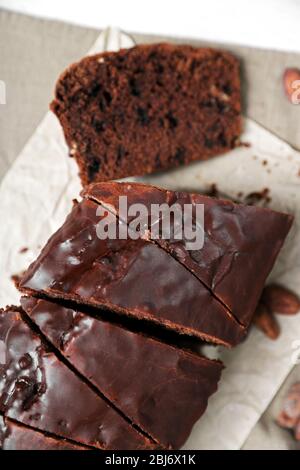 Torta al cioccolato con glassa su tovaglia Foto Stock