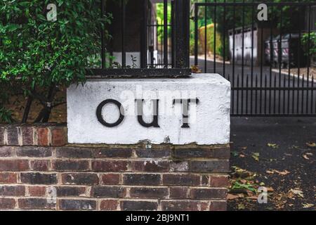 Indicazione "OUT" indicante la direzione del traffico sul territorio privato. Le indicazioni 'IN' e 'OUT' mostrano come accedere alla sede privata Foto Stock