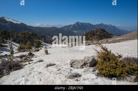 Vista dai monti Tahtali Dagi alla valle innevata. Famouse Tierist Lician Way in Turchia. Paesaggio soleggiato. Foto Stock