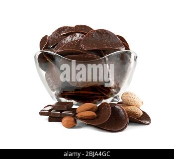 Scaglie di cioccolato e noci in vaso di vetro su fondo bianco Foto Stock