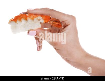 Femmina a mano con delizioso sushi di gamberi, isolato su bianco Foto Stock