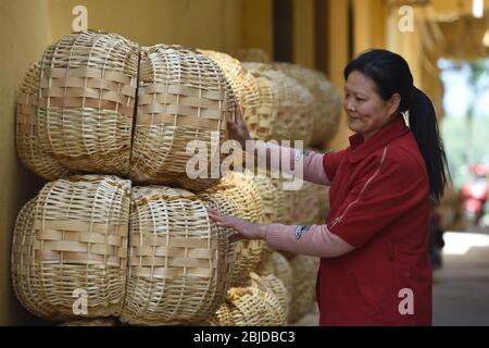 (200429) -- HEFEI, 29 aprile 2020 (Xinhua) -- una donna organizza prodotti di lavorazione del wickerwork in Gaotai Township della contea di Funan, provincia di Anhui della Cina orientale, 15 aprile 2020. La produzione di Wickerwork è stata un'industria importante per la riduzione della povertà locale. Le ultime nove regioni a livello di contea, colpite dalla povertà, nella provincia di Anhui, nella Cina orientale, sono state rimosse dall'elenco delle contee impoverite, secondo un annuncio pubblicato mercoledì dal governo provinciale. Ciò indica che tutte le 31 regioni a livello di contea impoverite dell'Anhui hanno scosso dalla povertà, nel mezzo degli sforzi del paese per sradicare Foto Stock