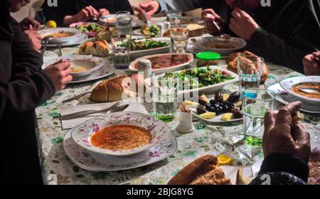 Affollata famiglia musulmana turca che ha iftar insieme in felicità con delizioso cibo vegano sul tavolo Foto Stock