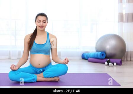 Giovane donna incinta allenarsi in palestra. Concetto di salute Foto Stock