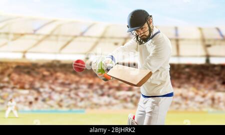 Battitore che colpisce palla durante Cricket una partita nello stadio Foto Stock