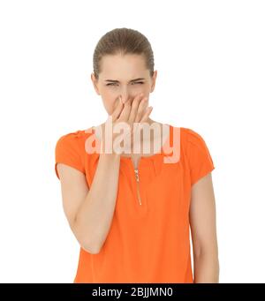 Giovane donna pizzicando il naso su sfondo bianco. Concetto di utilizzo del deodorante Foto Stock