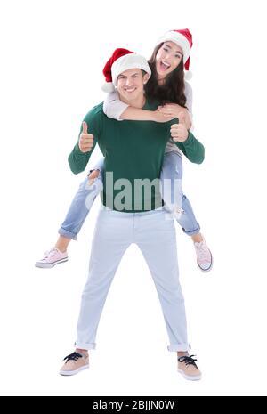 Felice giovane coppia in cappelli di Natale su sfondo bianco Foto Stock