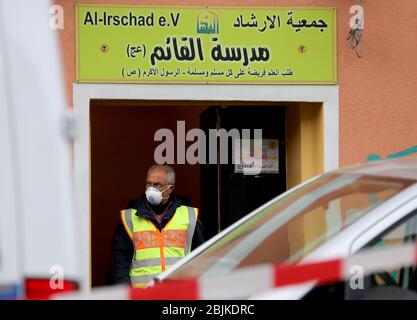 Berlino, Germania. 30 Aprile 2020. Un poliziotto con un boccaglio si trova all'ingresso della moschea al-Irschad. Il Ministro federale degli interni Seehofer (CSU) ha emesso un divieto contro Hezbollah. L’associazione islamista sciita deve ora fermare le sue attività in Germania. Gli agenti di polizia hanno cercato quattro moschee e associazioni all'inizio di questa mattina. Credit: Christoph Soeder/dpa/Alamy Live News Foto Stock