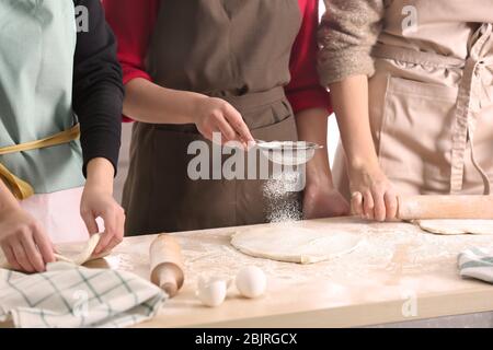 Giovani donne che preparano l'impasto per la pasticceria sul tavolo da cucina Foto Stock