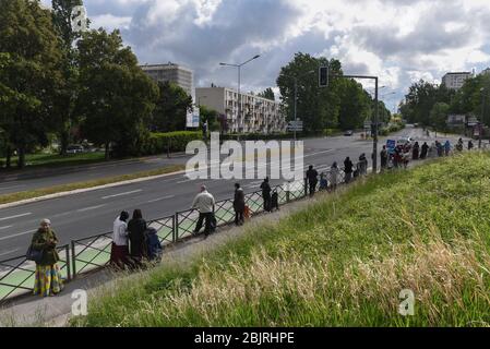 29 aprile 2020 - Clichy-sous-Bois, Francia: Una distribuzione di cibo ha luogo per i residenti di Clichy-sous-Bois durante il blocco contro l'epidemia di coronavirus. Questo sobborgo settentrionale di Parigi si trova a Seine-Saint-Denis, uno dei più poveri della Francia, che ha subito uno dei più alti tassi di contaminazione e di mortalità da Covid-19. I volontari del collettivo Aclefeu hanno fornito aiuti per quasi un migliaio di persone in occasione della sua occasione. Distribution de nourriture par le collectif Aclefeu pendant le consexement contre l'epidemie de covid-19. Les mesures contre le coronavirus ont a. Foto Stock