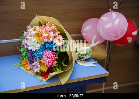 Un bouquet di fiori sul Table.Rainbow Daisies. Fiore arcobaleno di crisantemo. Mazzi di fiori arcobaleno Chryslanthemum . mazzo multicolore di Foto Stock