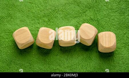 una fila di cubetti di legno vuoto su una carta verde di corteccia fatta a mano, concetto artigianale Foto Stock