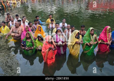 Durante il festival Chhath Puja, adoratori, per lo più migranti dalla provincia di Bihar, si trovano a Banganga Tank, Mumbai, India, per pregare verso il sole che tramonta Foto Stock