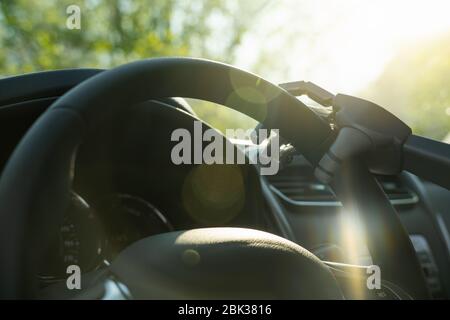 Braccio del robot su un volante. L'intelligenza artificiale guida un'auto. Concetto di veicolo autonomo. Foto Stock