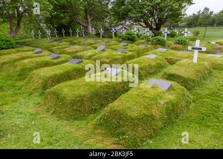 Tumuli per tombe nel cimitero della chiesa di Hofskirkja, una bella chiesa di erba sintetica nella regione di Öræfi, nel sud-est dell'Islanda. Foto Stock