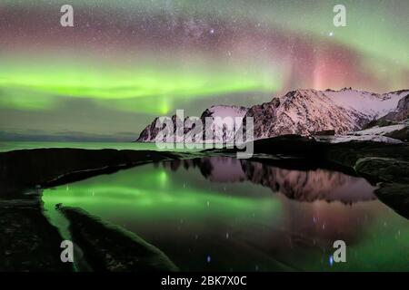 Aurora boreale sulla spiaggia di Ersfjord. Isola di Senja di notte, Europa isola di Senja nella regione di Troms della Norvegia settentrionale. Scatto a lunga esposizione. Foto Stock
