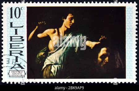 LIBERIA - CIRCA 19669: Un francobollo stampato in Liberia mostra David e Goliath, Pittura di Carvaggio, circa 1969 Foto Stock