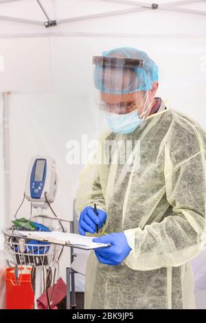 Gli operatori sanitari testano CoVid19 e discutono dell'antidoto e dei test in una tenda sterile a turni durante l'epidemia globale. Foto Stock