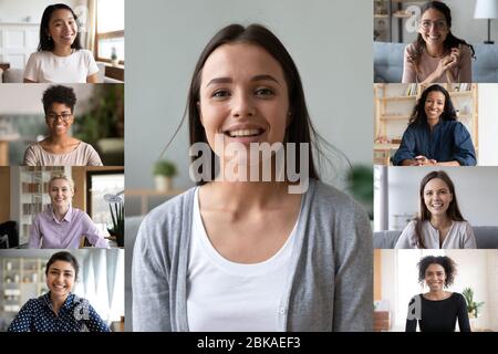 Sorridendo donne diverse impegnate in videochiamate di squadra a casa Foto Stock