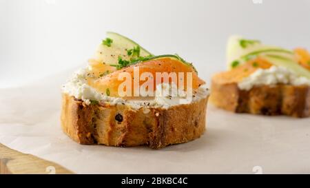 Panino al salmone con baguette francese, formaggio morbido e cetriolo. Foto Stock