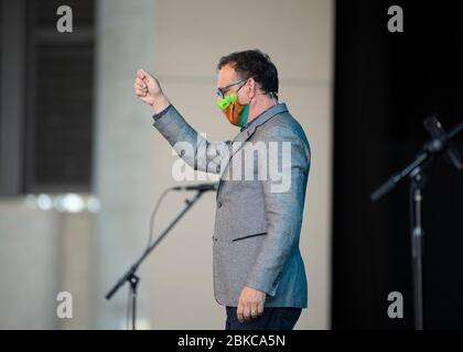 Indossando una maschera facciale, Pastor Randy Phillips guida il servizio come LifeAustin Chiesa di adorare di persona per la prima volta in oltre sei settimane al teatro all'aperto da 1,500 posti a ovest di Austin. I dirigenti della Chiesa hanno limitato il gruppo a 325 adoratori con biglietto, mentre richiedevano maschere e distanze sociali a causa della pandemia di coronavirus. Foto Stock