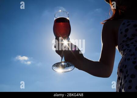 bagliore del sole in un bicchiere di vino rosato Foto Stock