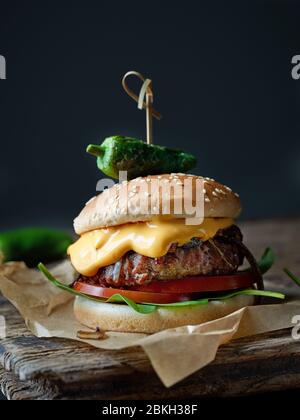 Freschi e saporiti burger on dark tavolo in legno Foto Stock