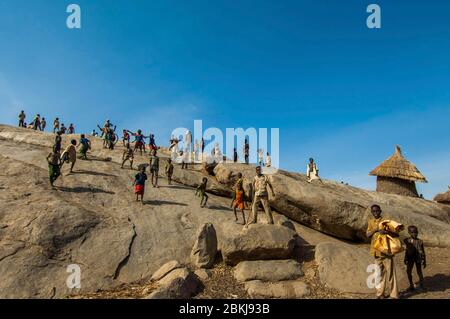 Sudan, sud Kordofan, Nuba Hills, Nyaro, bambini che giocano su affioramenti rocciosi che si affacciano sul villaggio Foto Stock