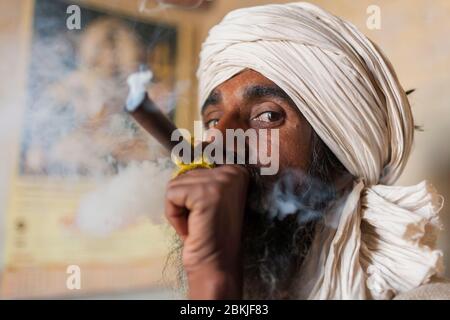 India, Rajasthan, kolayat, ritratto di un sadhu fumare hashish in uno shilum Foto Stock