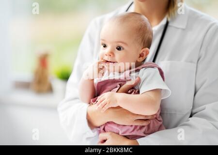 medico pediatra femminile con bambino in clinica Foto Stock