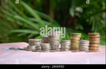 Monete in pila sul tavolo. Verde sfondo natura. Concetto di finanza o denaro. Foto Stock