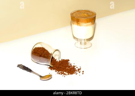 Una tazza di caffè dalgona ghiacciato, caffè panna frulosa alla moda su uno sfondo colorato alla moda. Foto Stock