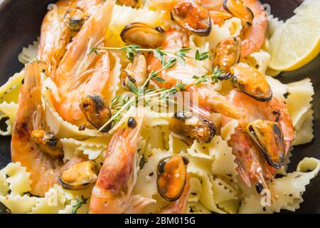 Pasta Mafaldine o reginette con pesce, gamberi, cozze, primo piano. Piatti tradizionali in Italia. Foto Stock