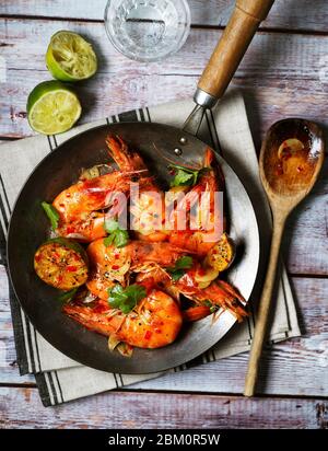 Gamberi fritti al peperoncino e aglio in padella Foto Stock