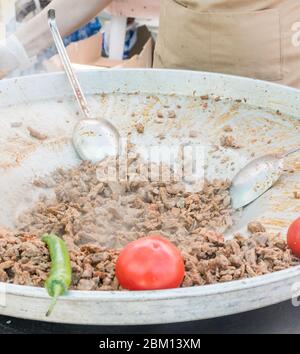 Tradizionale carne di shawarma turca preparata con pomodori rossi e peperoni rossi e verdi, disponibile per la vendita in un mercato alimentare di strada, selettivo per il Foto Stock