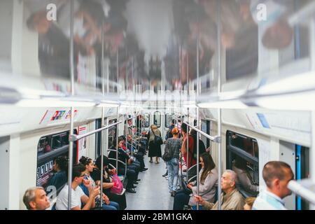 MOSCA, RUSSIA - 7 LUGLIO 2017: Passeggeri in un'auto metropolitana e una donna anziana solista si alza Foto Stock