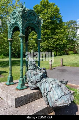 Scultura temporanea della regina Victoria busking con fischio di stagno e corona di collezione da una fontana d'acqua su Christchurch Green a Clifton Bristol Regno Unito Foto Stock