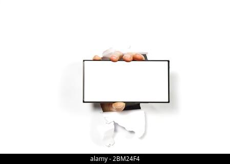 telefono cellulare nelle mani del mocap. mano a contatto con il telefono isolato su uno smartphone bianco, mock-up schermo bianco Foto Stock