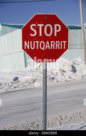 Segno rosso stop in inglese e Inuinnaqtun nella comunità di Cambridge Bay, Nunavut Foto Stock