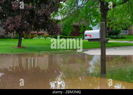 Casella postale su una strada allagata in una città del Midwest Foto Stock