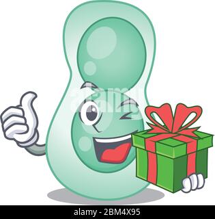 Sorridente personaggio di serratia marcescens cartoon con una scatola regalo verde Illustrazione Vettoriale