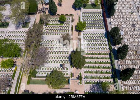 Cimitero militare al Memorial Day con bandiera sventolante e ufficiali dell'esercito in uniforme bianca, vista aerea. Foto Stock