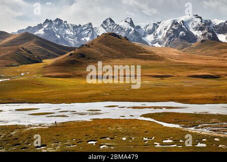 Vista aerea della bellissima valle di montagna con piccolo turista e fiume vicino a Kel Suu lago nella regione di Naryn, Kirghizistan Foto Stock