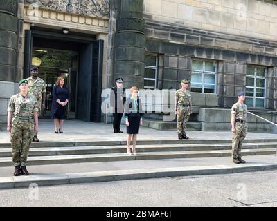 Il ministro scozzese Nicola Sturgeon osserva un silenzio di due minuti accanto (da sinistra a destra) alla corporale dell'esercito britannico Fiona Williamson-Jones, al tenente della Royal Navy Donovan Davy, segretario di gabinetto per l'economia, il lavoro equo e solidale e la cultura Fiona Hyslop, capo del Constable Iain Livingstone QPM, Il funzionario dell'esercito britannico Classe 1 Edinburgh Garrison Sergeant-Major Scott McFadden e il funzionario di volo RAF Luke Hilton fuori dalla St Andrew's House di Edimburgo, per celebrare il 75° anniversario del VE Day. Foto Stock