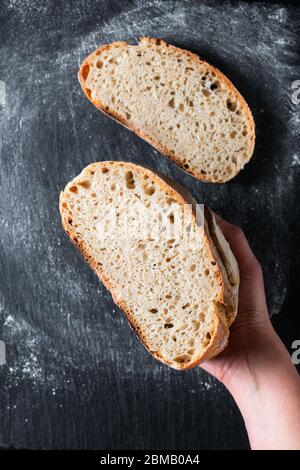 Umore scuro e tono Casa cucina casalinga rustico biologico pane di pasta di sourstangle su sfondo nero con spazio per le copie Foto Stock