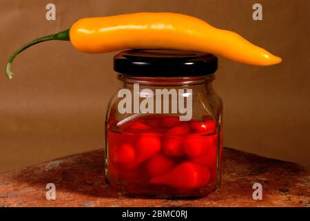 contenitore in vetro con peperoni caldi da vicino Foto Stock