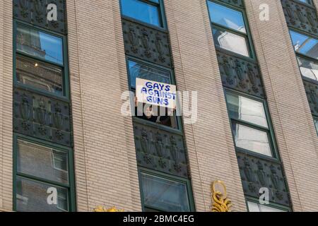 Un uomo tiene un cartello che legge "Gays Against Guns" durante la marcia per la nostra vita per la sicurezza delle armi. Foto Stock