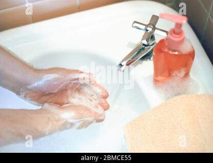 Uomo che lava le mani. Si raccomanda un frequente lavaggio delle mani per ridurre il rischio di diffusione di Covid 19 o Coronavirus nel 2020 Foto Stock